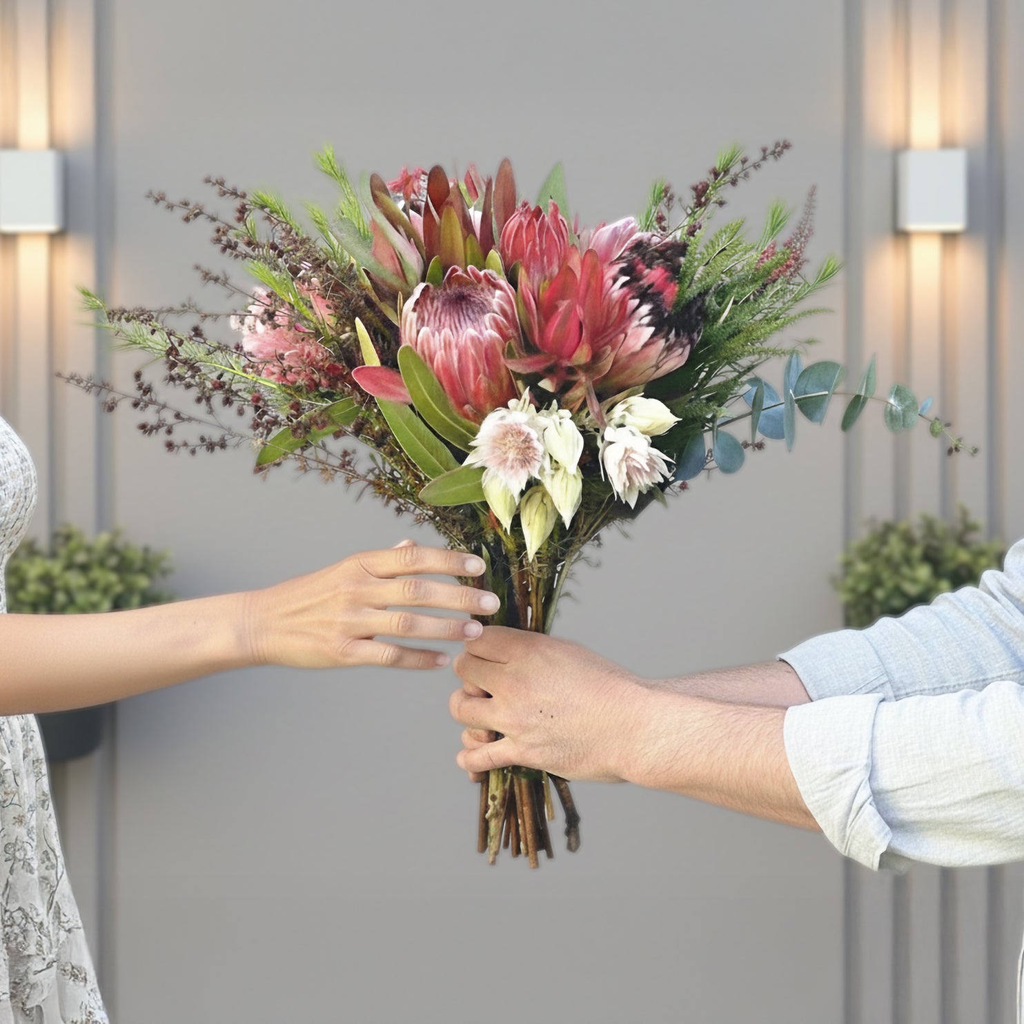 Buy Protea Bouquet - person handing another person a protea bouquet